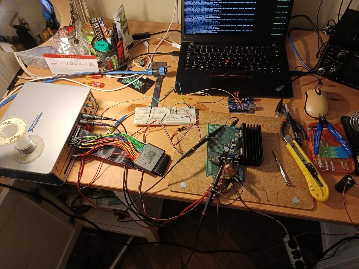 The bench: VirtualBench, laptop on the serial port, Uno and breadboard driving the amplifier board on the cork mat